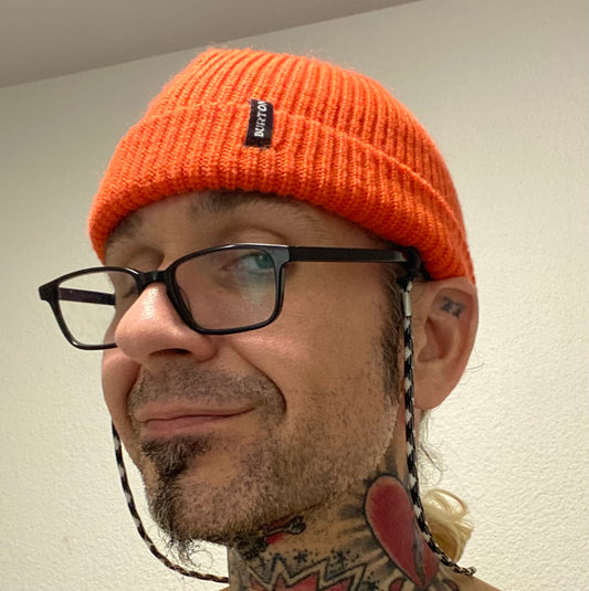 A picture of a man in glasses and a winter beanie